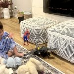 child playing with toys on the living room floor