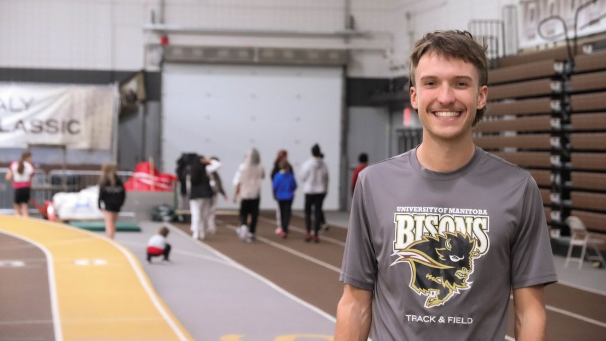 Calvin Reimer stands in front of a group of CanU kids