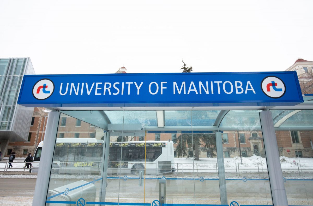 outdoor image of blue bus stop signage at fort garry campus that reads university of manitoba