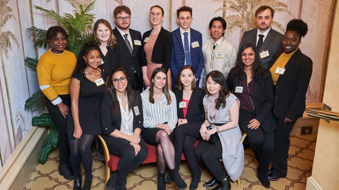 A group of 14 students dressed in business clothes.