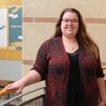 Michaela Bourque stands in the atrium of the College of Nursing's Helen Glass building on Fort Garry campus.