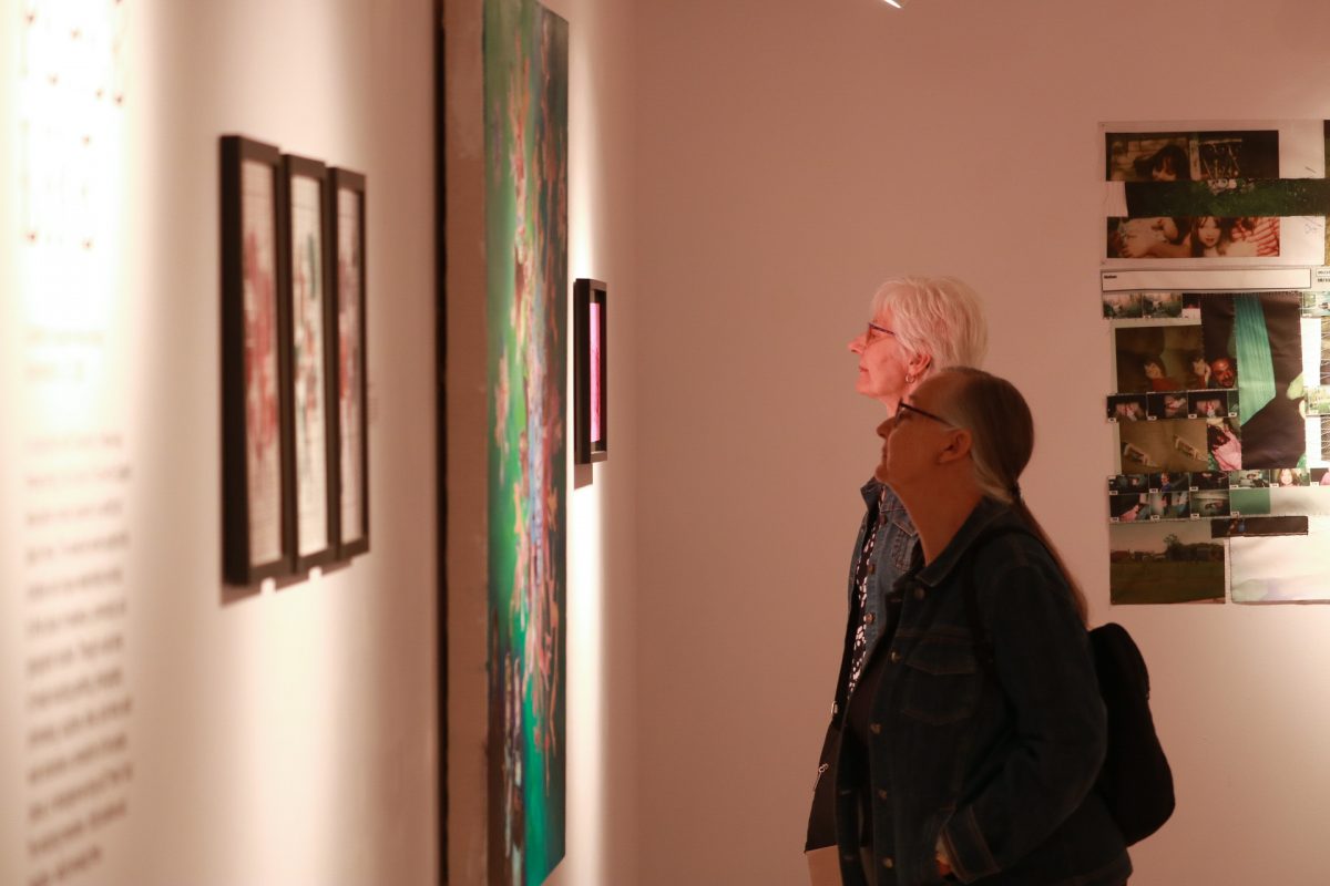Two people looking at artwork.