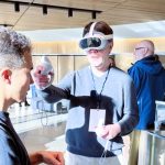 A person wearing a VR headset and holding VR controllers.