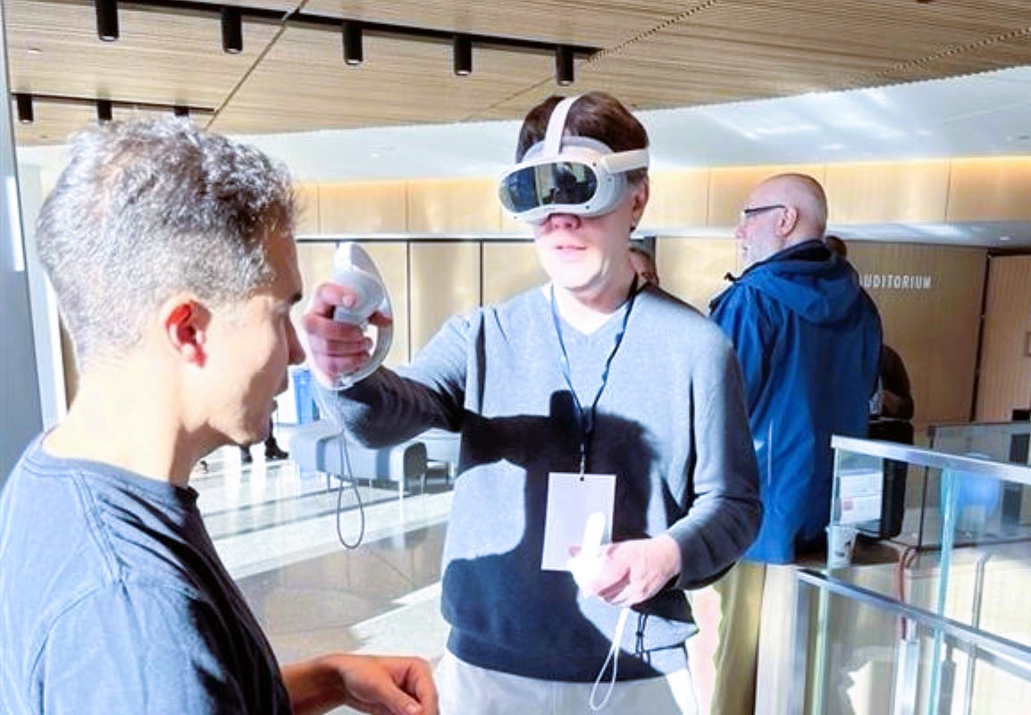 A person wearing a VR headset and holding VR controllers.