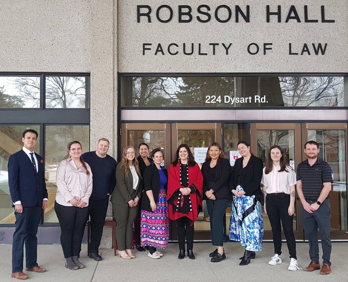 The Honourable Michelle O'Bonsawin, Justice of the Supreme Court of Canada with law students in front of Robson Hall, Faculty of Law building.