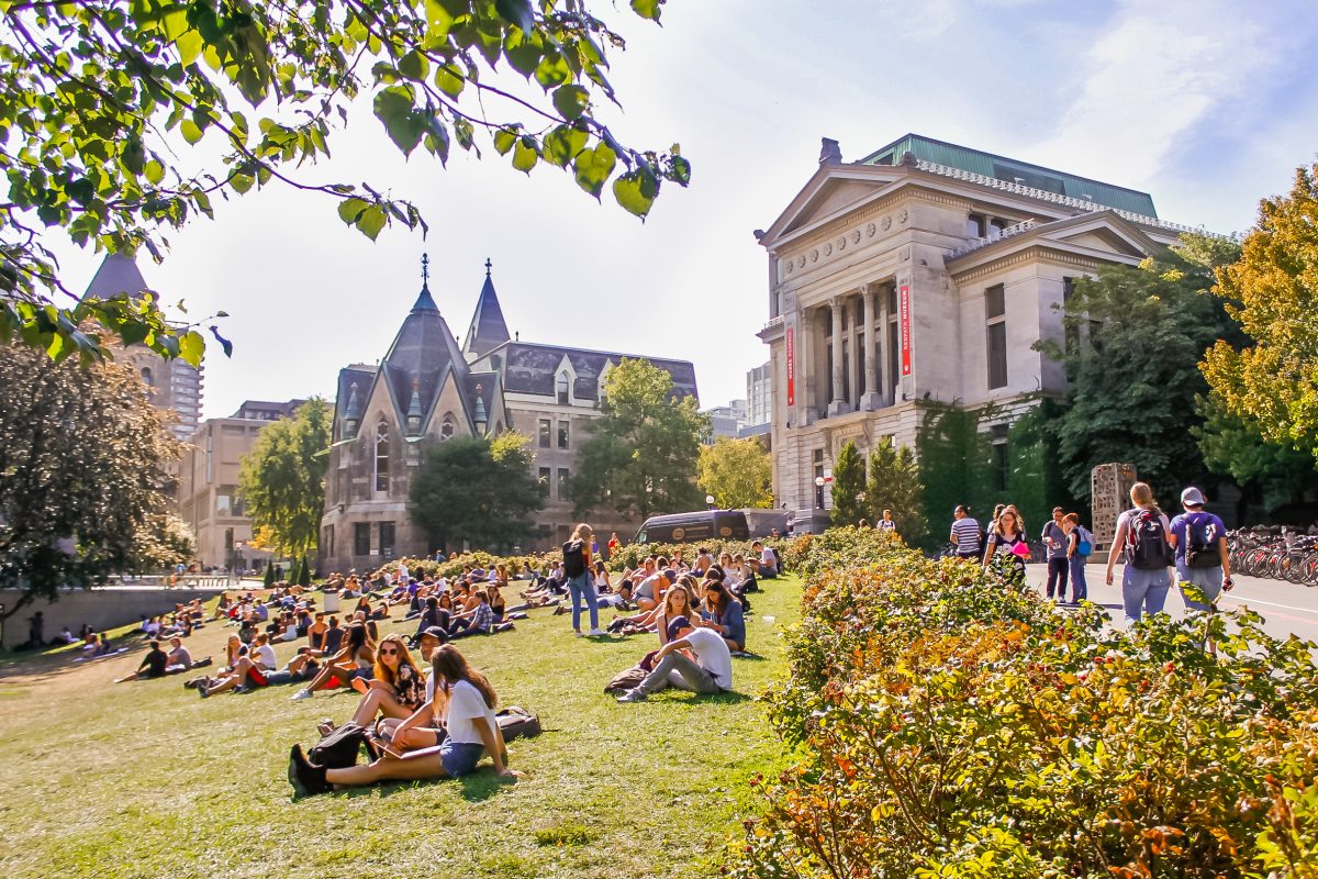 Students lounging on "the beach" in front of Redpath Museum. Valeria Lau | McGill University (April 2018)