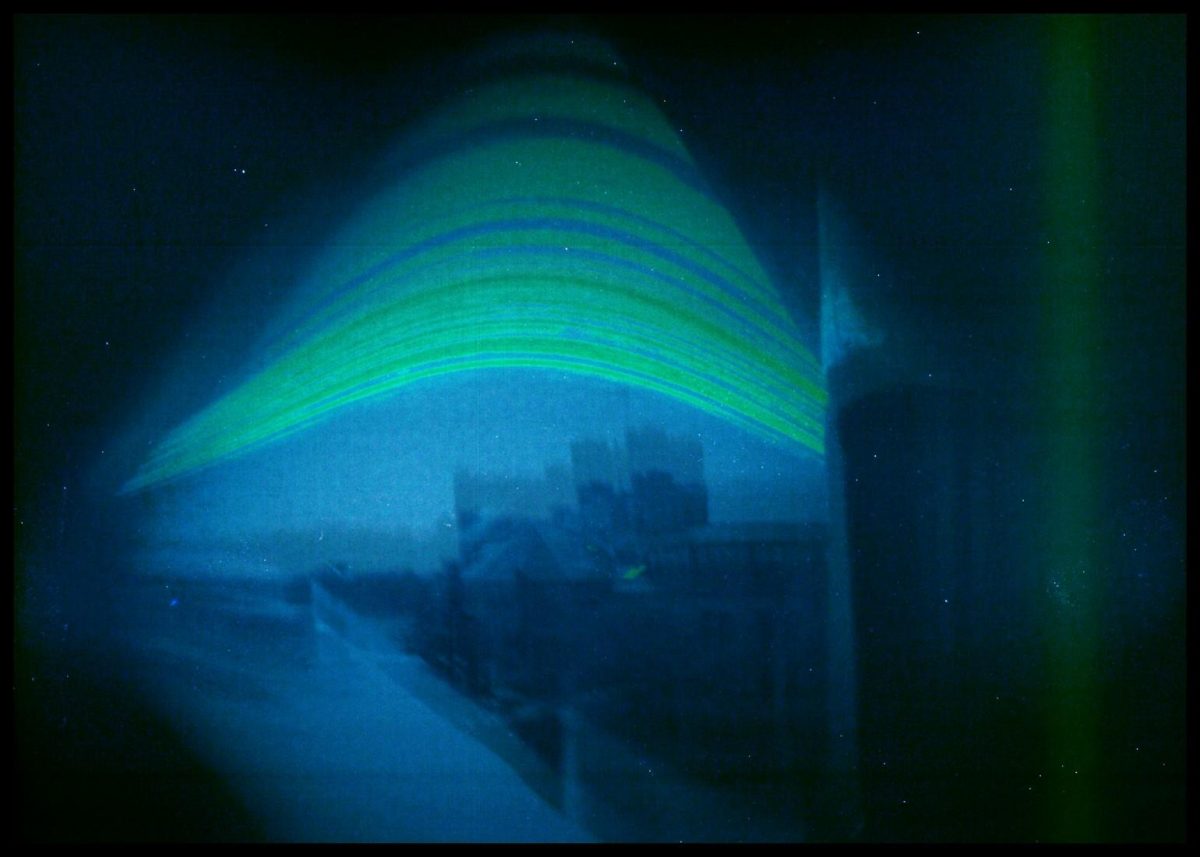 This image is a solargraph. It shows a view from a south-facing window on sixth floor of Fletcher Argue building. The green arcs trace a semester’s worth of the sun’s daily movement across the sky.