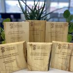 Reclaimed wood Sustainability Award plaques on display.