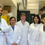 A group of scientists in white lab coats.