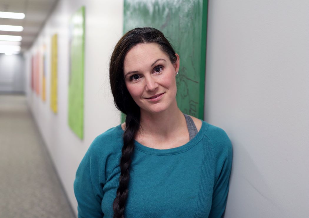 Dr. Laura Bowler stands in a hallway at the University of Manitoba.