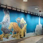 A painting in progress, of a person and animal in a boat