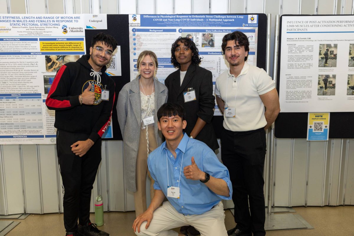 Students posing in front of poster during Research Day 2024