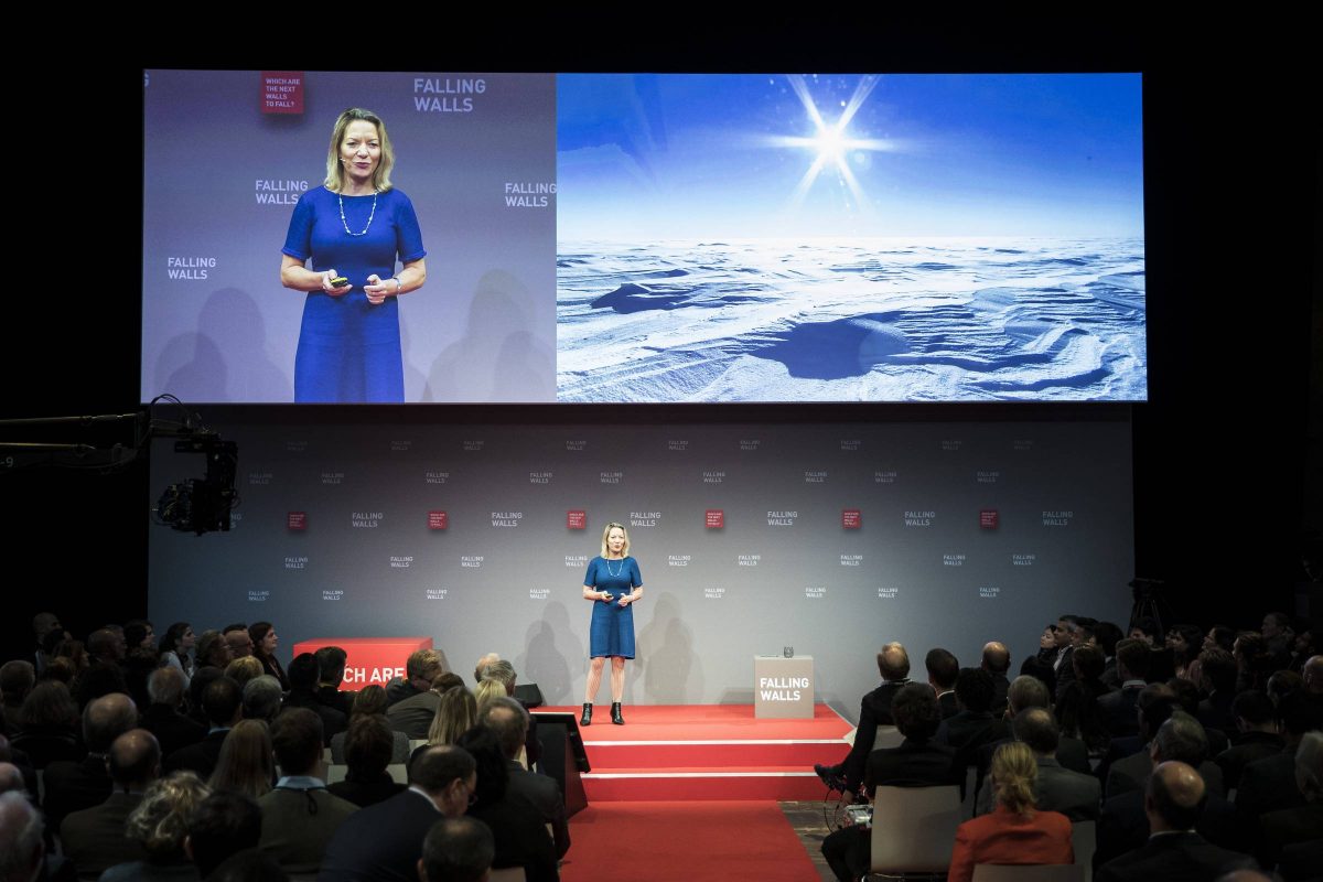 A presenter engages the audience on the Falling Walls stage.