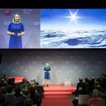 A presenter engages the audience on the Falling Walls stage.