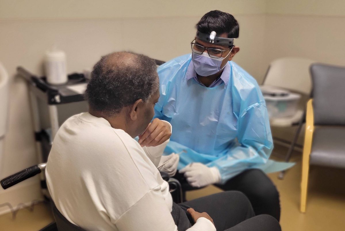 Dentist helping patient