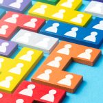 Image of different coloured puzzle pieces with person icon