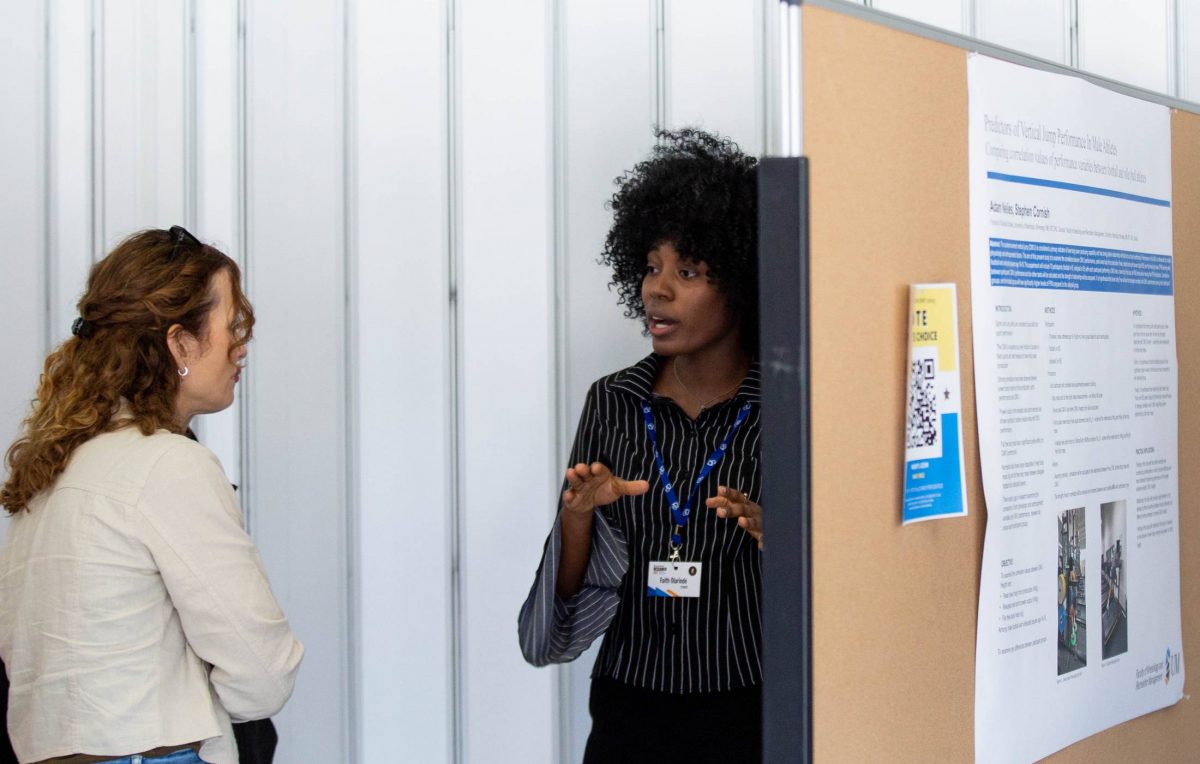 Faith Olarinde presents to a judge at research day 2023