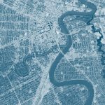 An aerial view of Winnipeg's downtown and rivers with a blue overlay filter.
