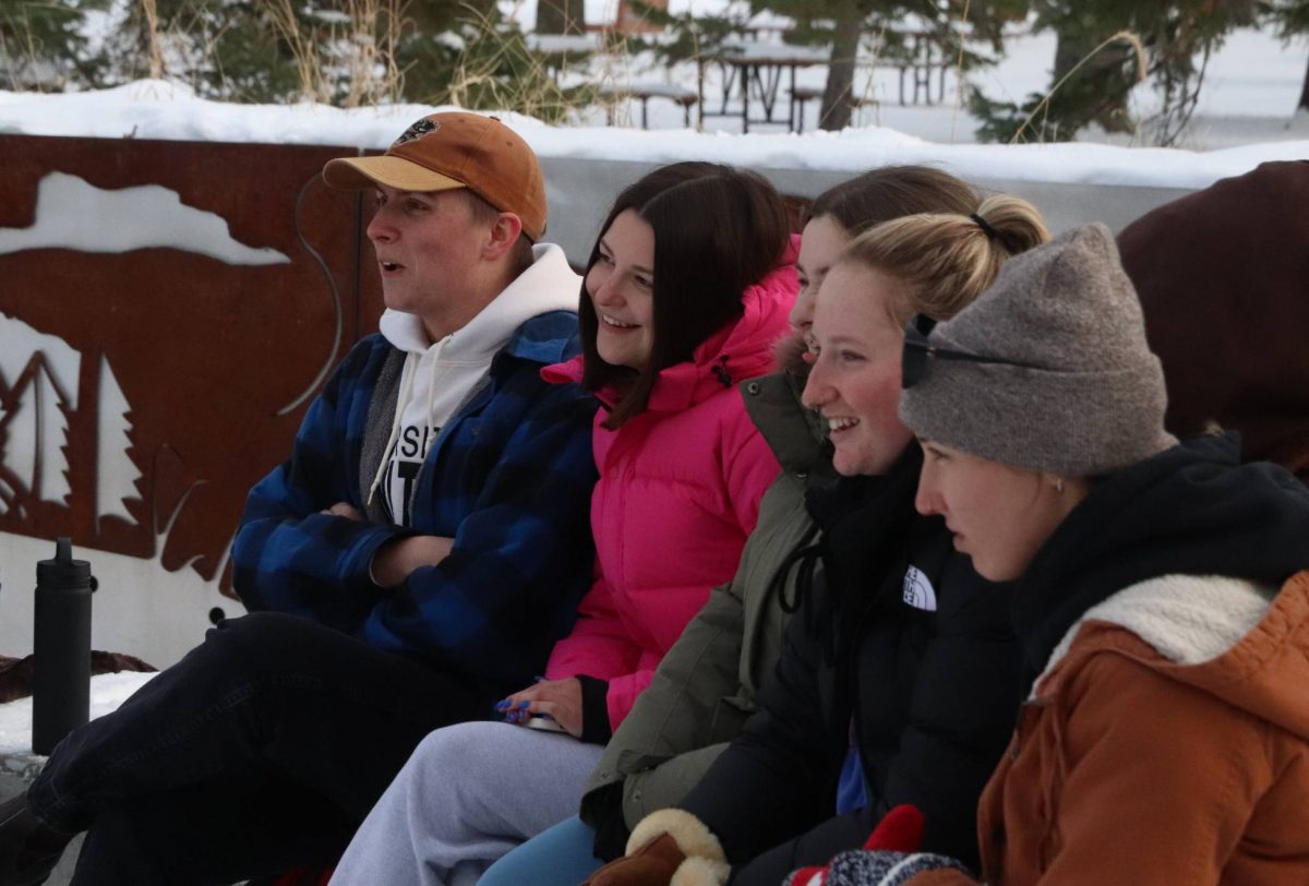 A group of students laughing during an outdoor lesson