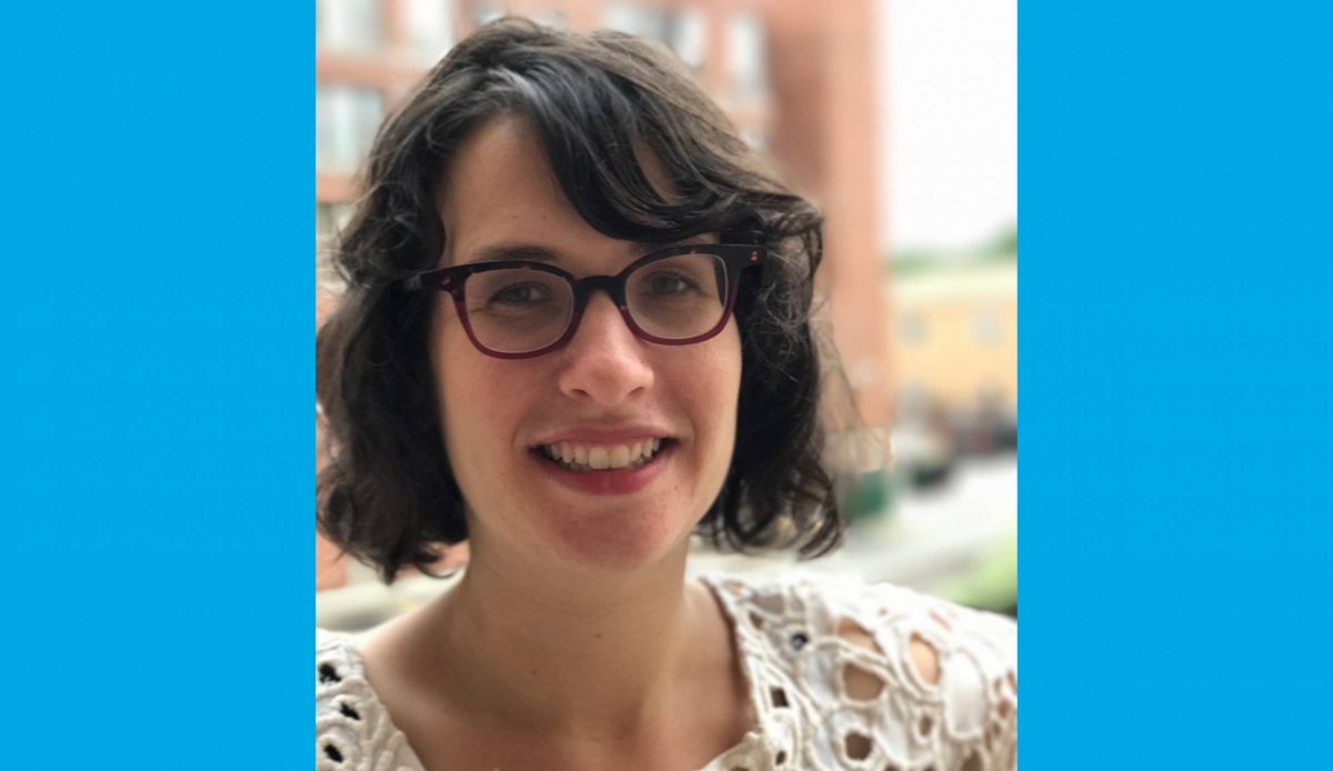 Dr. Orly Linovski smiles outdoors.