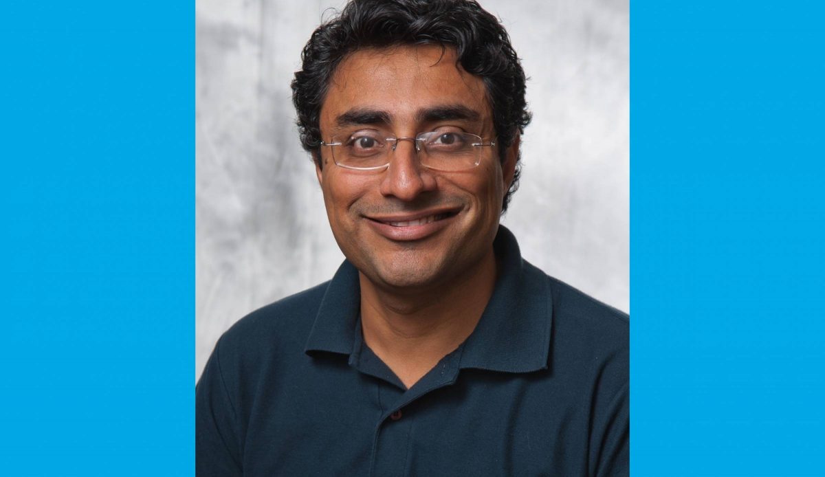 Dr. Sandeep Arora wears a dark blue polo shirt.