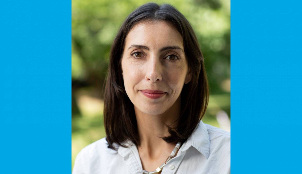 Dr. Leslie E. Roos headshot, taken outside in afternoon light.