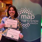 Theodore Biggs-Engel posing with two awards at Map the System