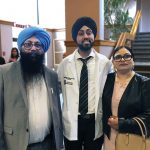 Graduate standing between his parents.
