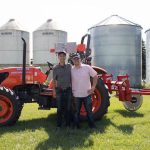 Chris and Casey smiling at the camera at the soil reader field.