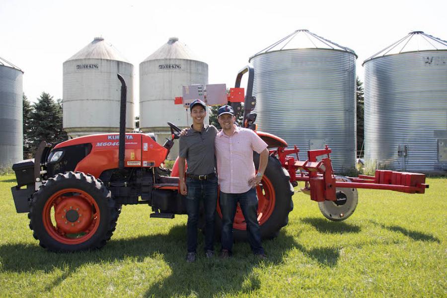 Chris and Casey smiling at the camera at the soil reader field.