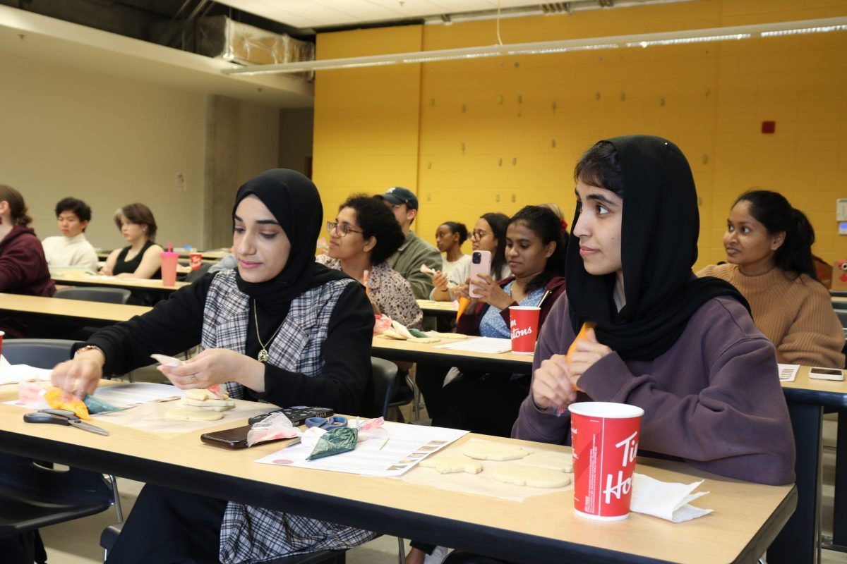 female-identifying students decorating cookies