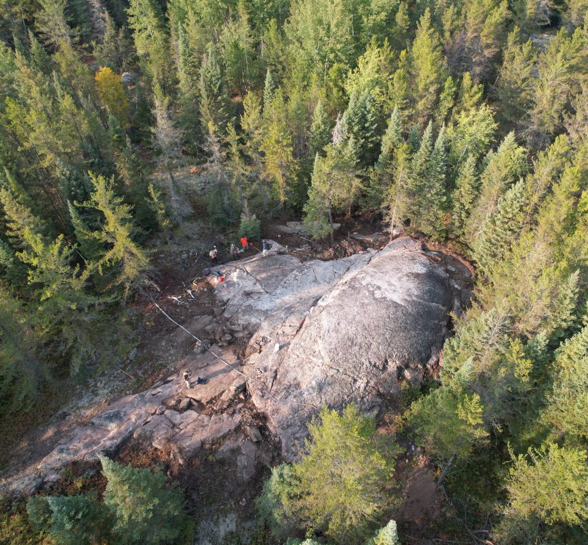 A drone captures mineral exploration amidst forests of the Canadian Shield.