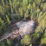 A drone captures mineral exploration amidst forests of the Canadian Shield.