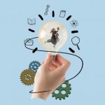 Graphic of a hand holding a lightbulb in which a tiny person is shown running while holding a book the hand and lightbulb are surrounded by gears and sketches of books, science, a magnifying glass and other objects to indicate ideas and learning
