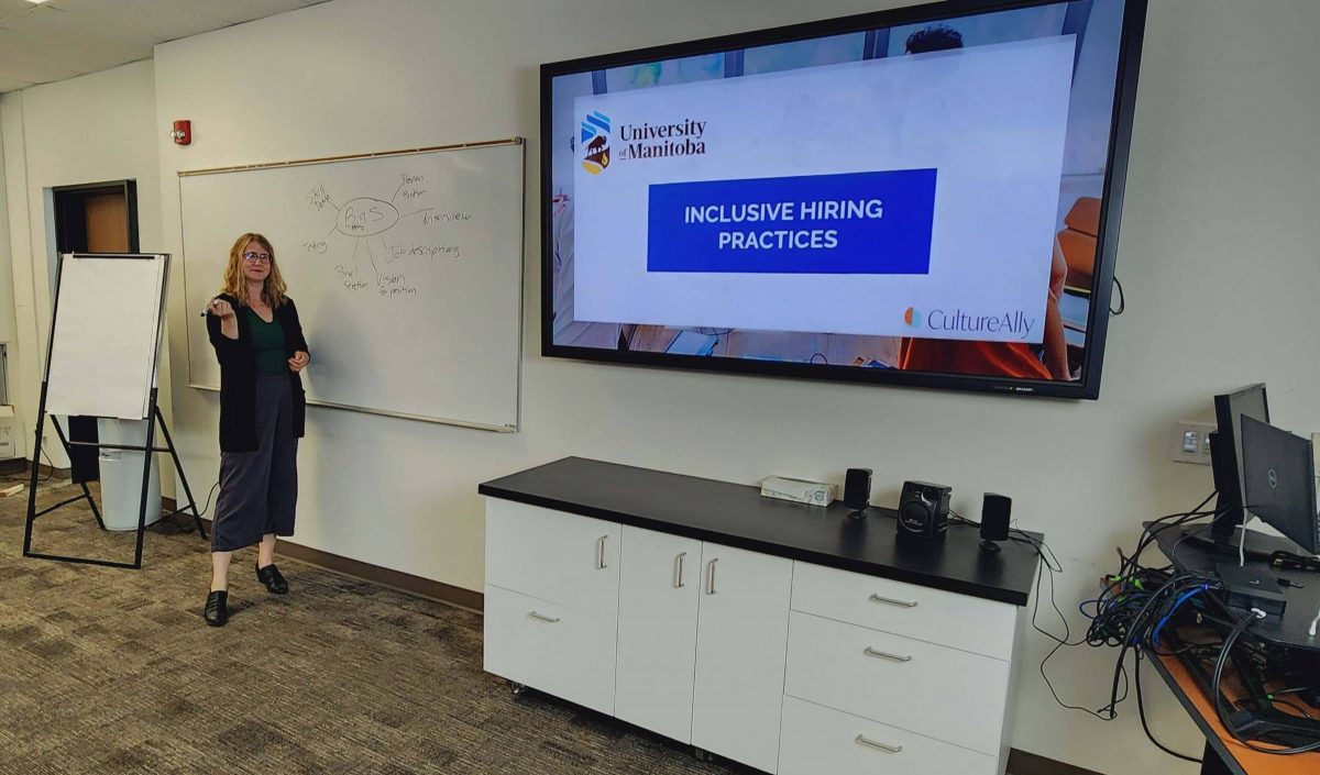 A woman giving a presentation in front of screen.
