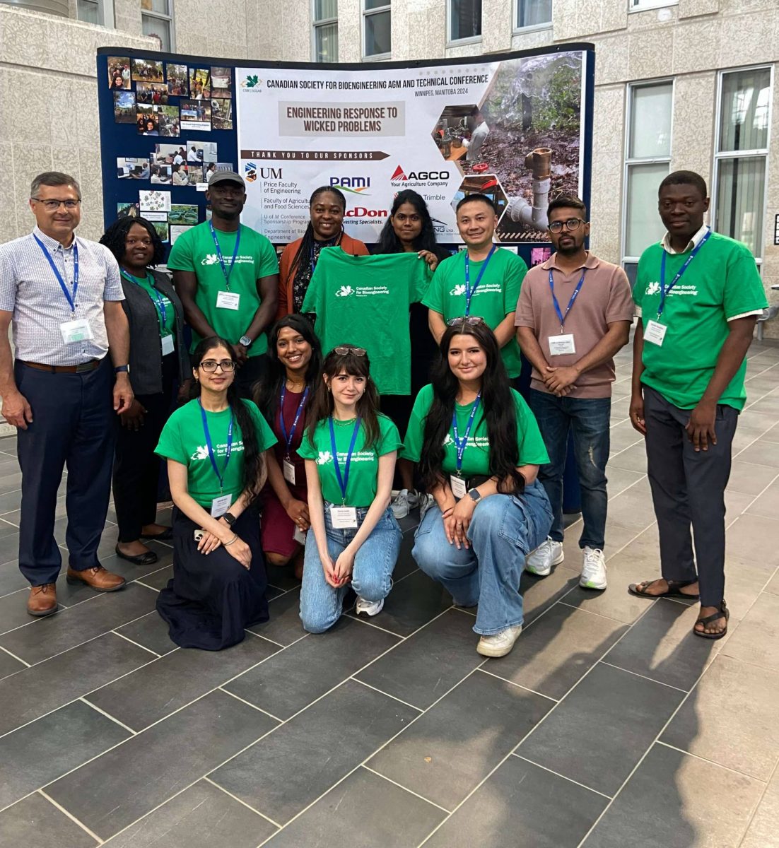 A group of people posing in front of a banner