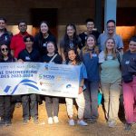 A group of people holding a banner