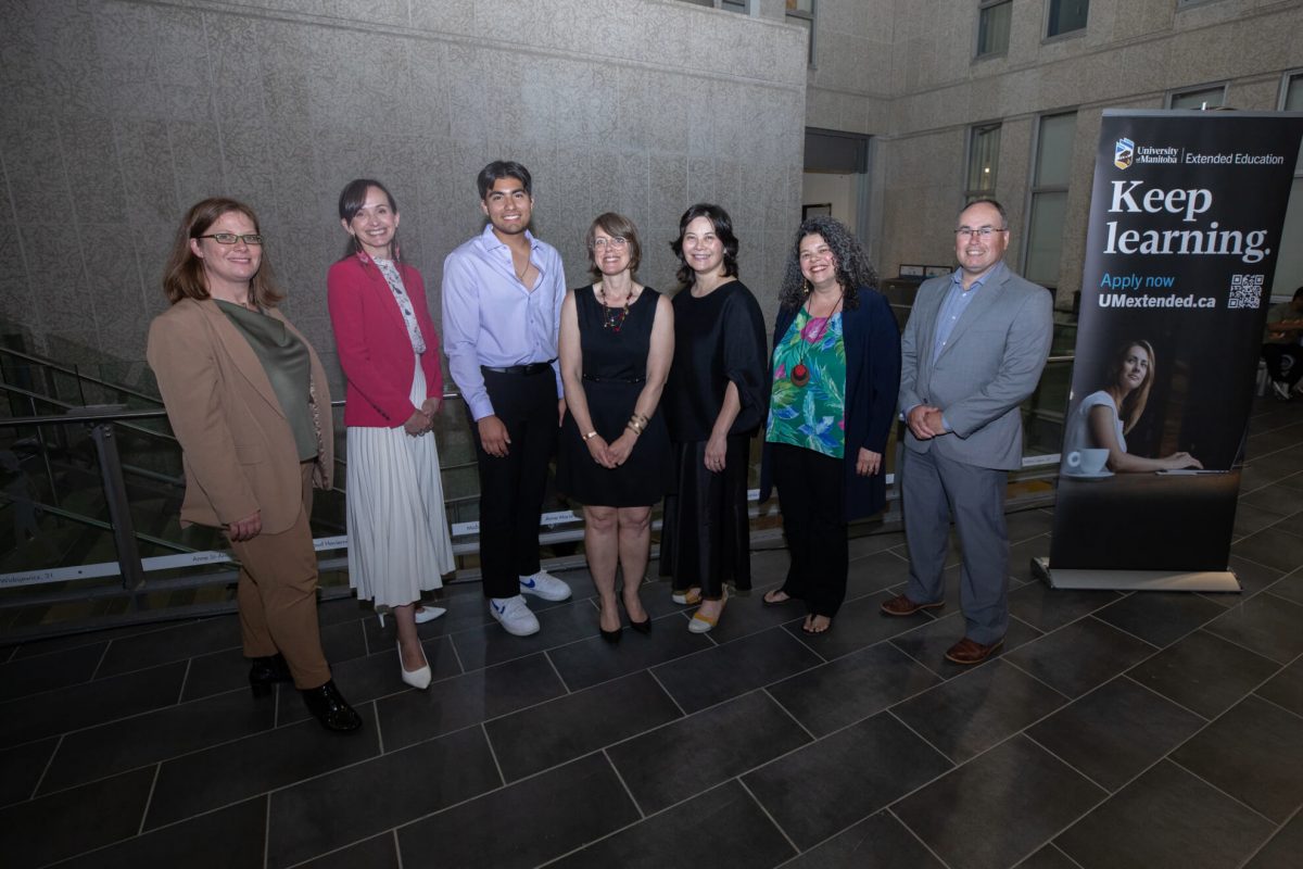 Group of people in front of banner sign for Extended Education courses