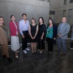 Group of people in front of banner sign for Extended Education courses