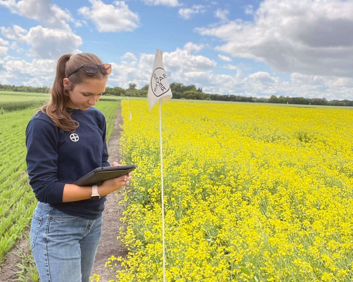 Gabriella Beckta Bayer working next to a Bayer field