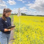 Gabriella Beckta Bayer working next to a Bayer field