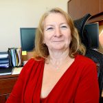 woman with red sweater and smiling