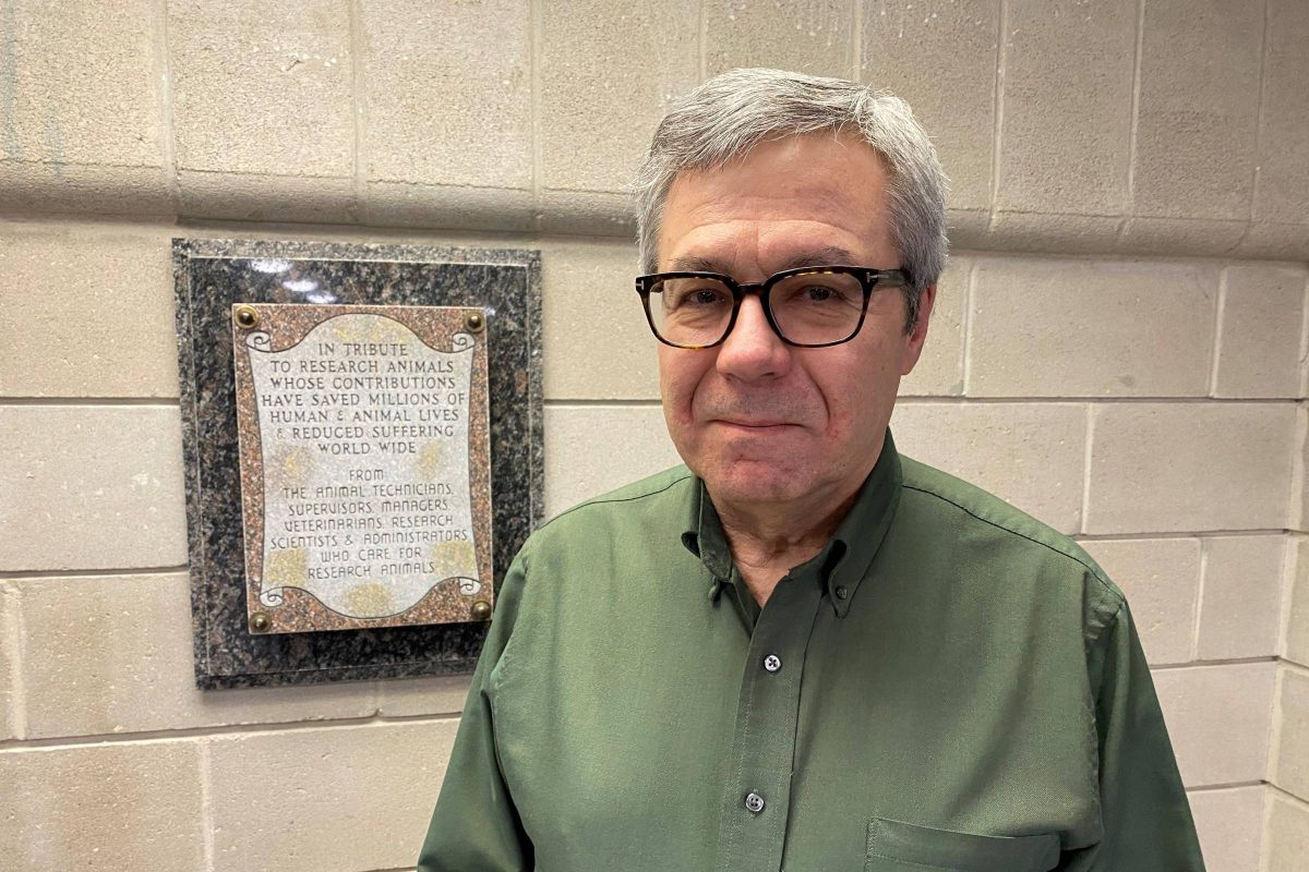 Robert Madziak stands next to plaque commemorating the contributions of research animals.