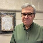 Robert Madziak stands next to plaque commemorating the contributions of research animals.
