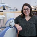 Kathy Yerex leans on a dental chair in the UM dental school's clinic.