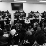 young people gather in a barber shop as part of an outreach workshop
