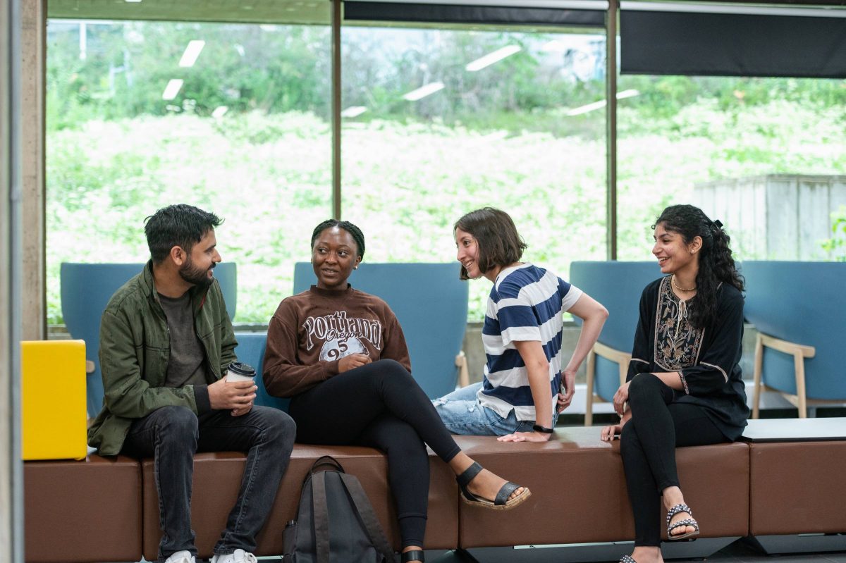 Students sitting on bench talking