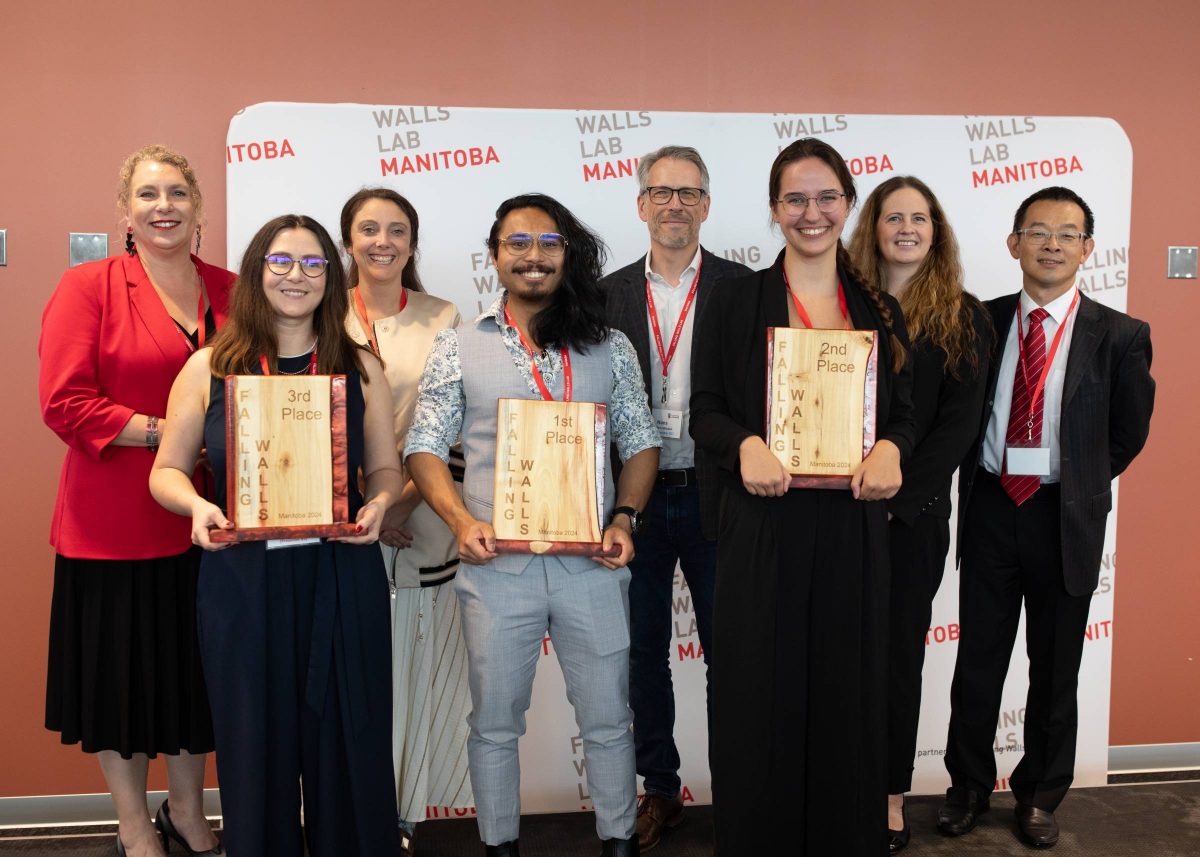 Winners and judges pose together with the Falling Walls Manitoba trophies.