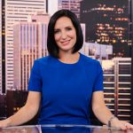 Amanda Lang sitting behind a news desk