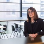 Dr. Silvia Alessi-Severini stands at a counter in a student lounge.